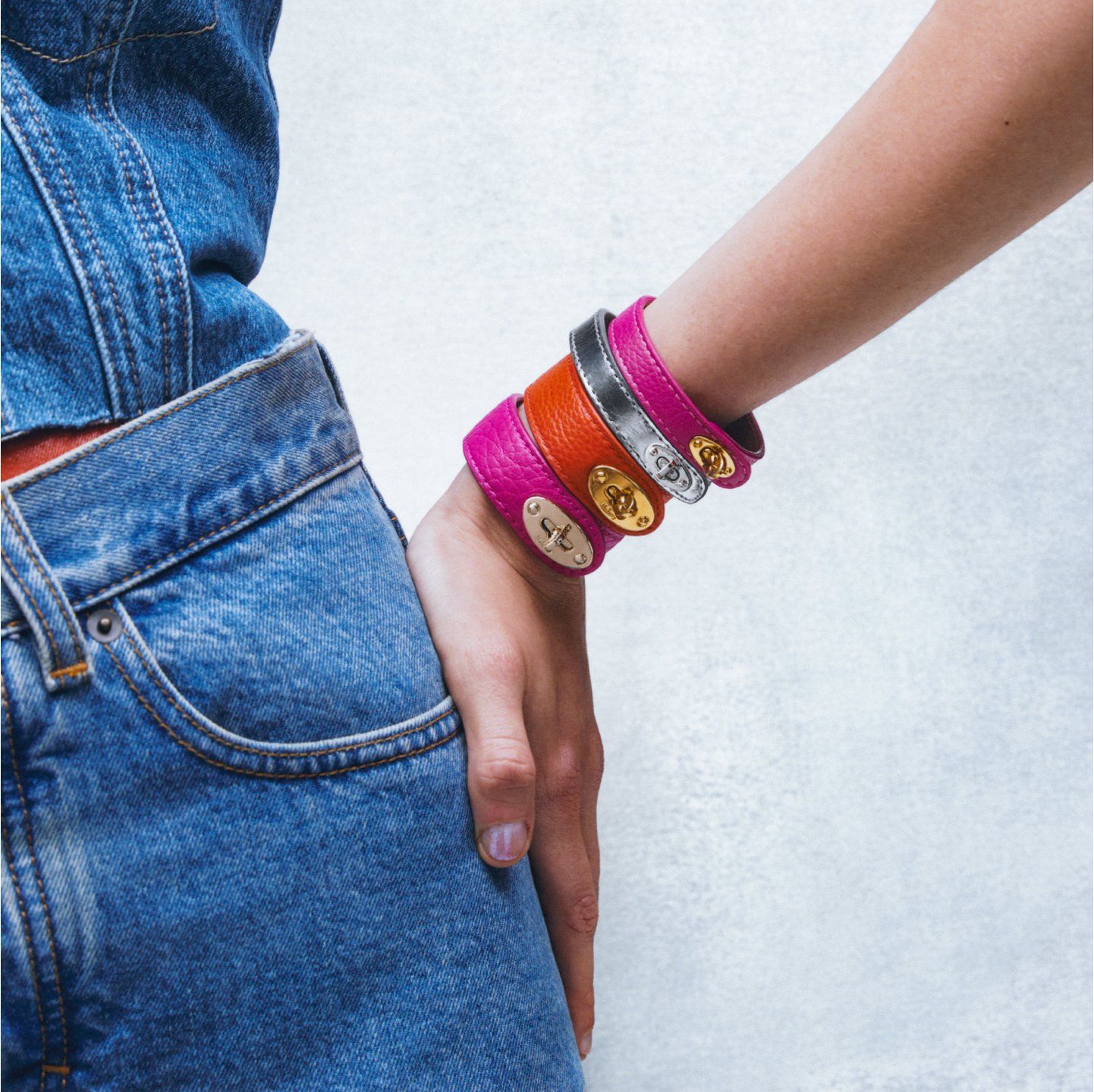 model wearing four mulberry bayswater bracelets pink, orange and silver